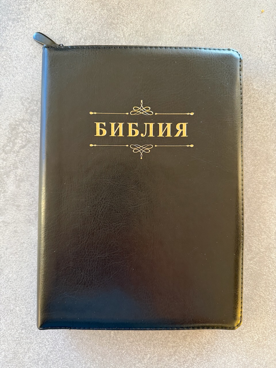 Дисконт. Небольшая полоска (в виде зацепки), в правом углу на лицевой обложке чуть ниже центра. Библия 076z код 23076-37,  надпись "Библия" золотом , переплет из искусственной кожи на молнии, цвет черный, размер 180x243 мм